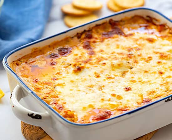 Baking dish full of hot cheesy buffalo chicken dip