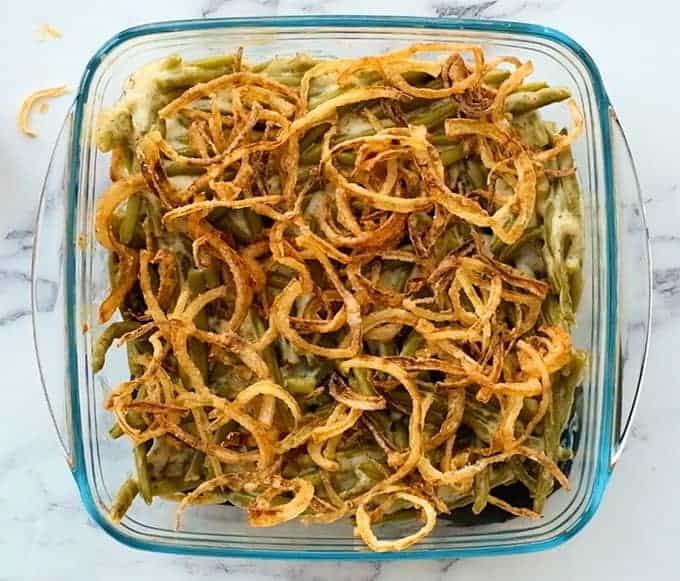 baking dish of baked green bean casserole with fried onions on top