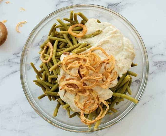 Bowl of canned green beans, condensed cream of mushroom soup, and French's fried onions
