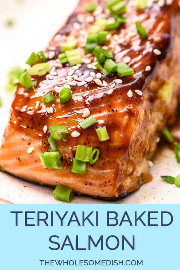 Baked teriyaki salmon on a plate sprinkled with sesame seeds and sliced green onions