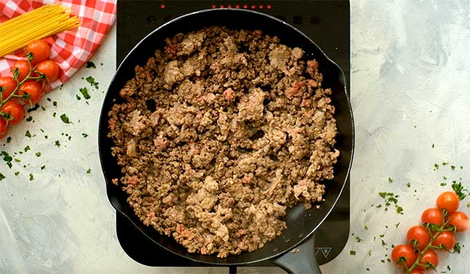 ground beef and italian sausage cooking in a skillet