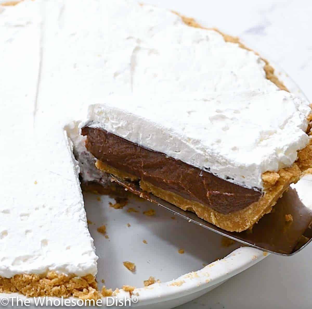 a slice of chocolate cream pie being lifted out of the pie plate