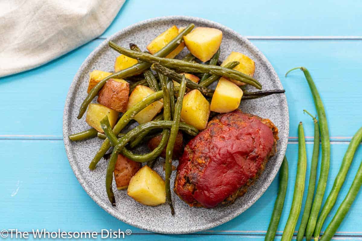 Mini meatloaf, roasted potatoes, and green beans on a plate