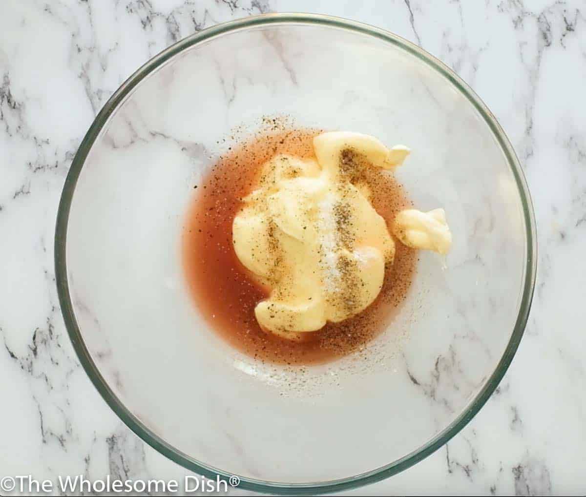 Bowl of mayo, vinegar, sugar, salt, and pepper for homemade dressing