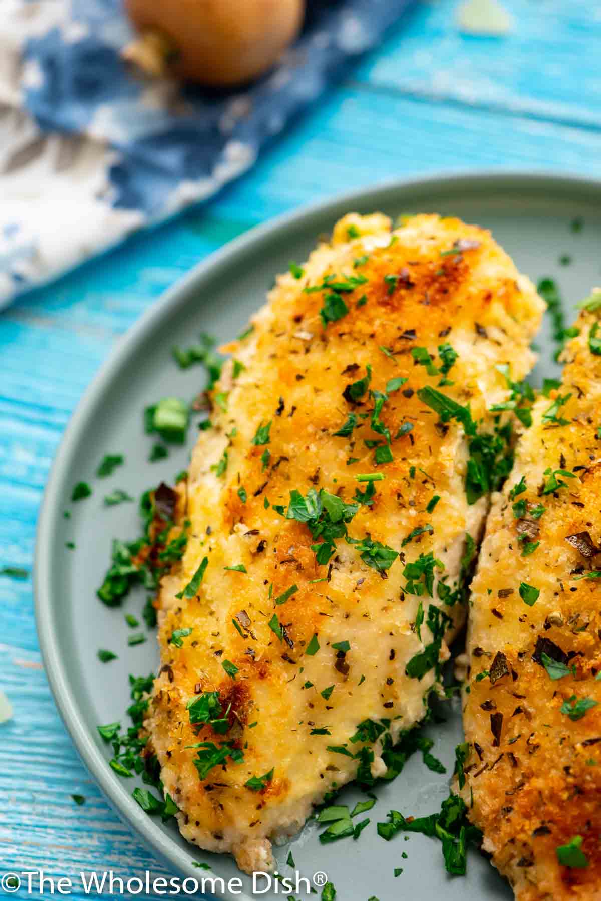 baked parmesan crusted chicken breast on a plate