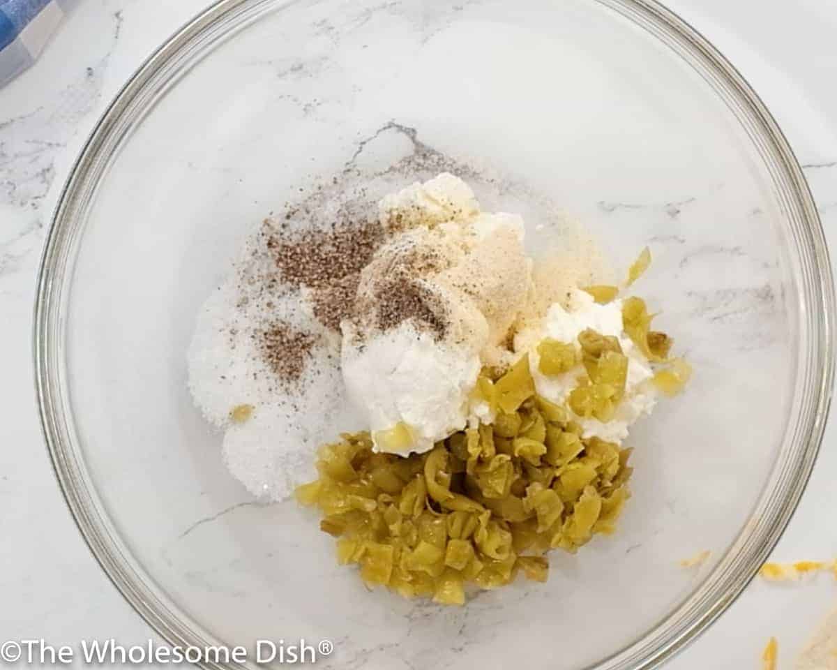 Mixing bowl with cream cheese, green chilis, and seasonings