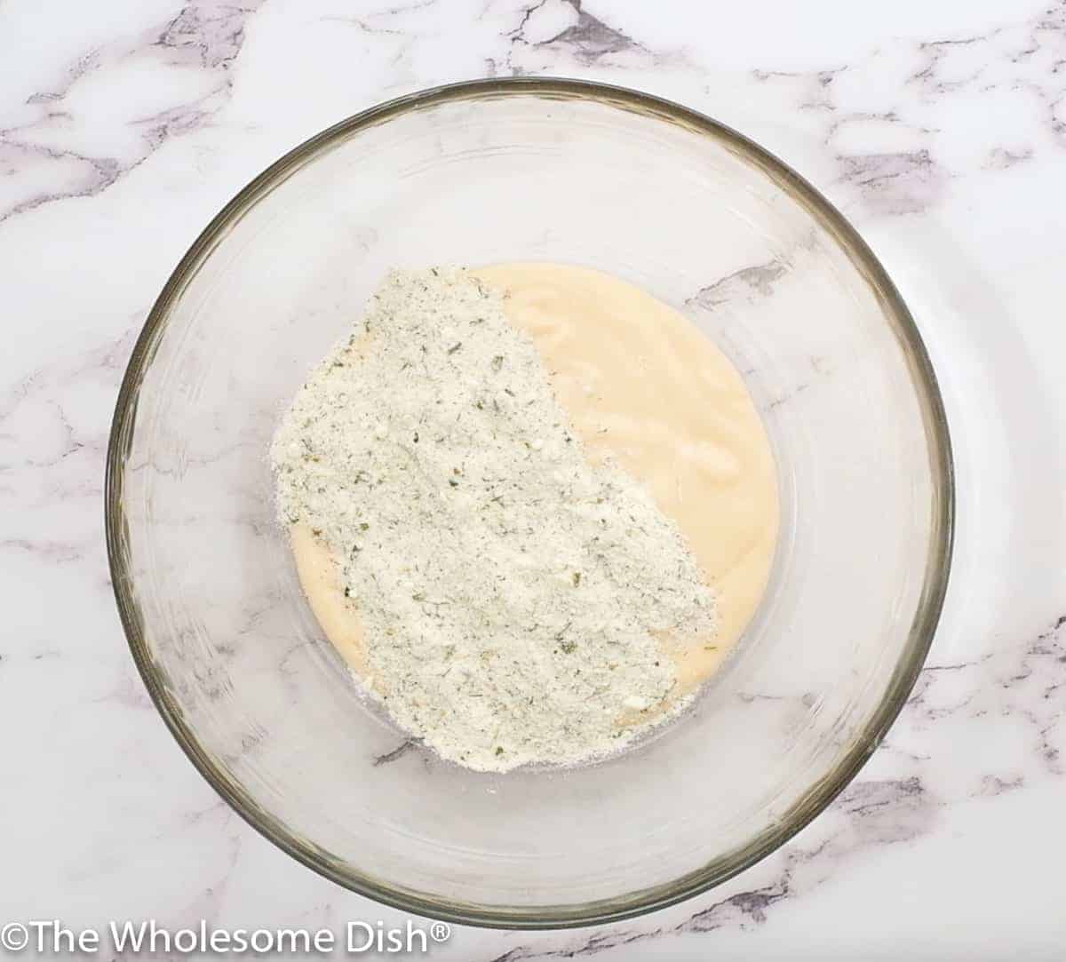 cheddar cheese soup and dry ranch seasoning in a mixing bowl.