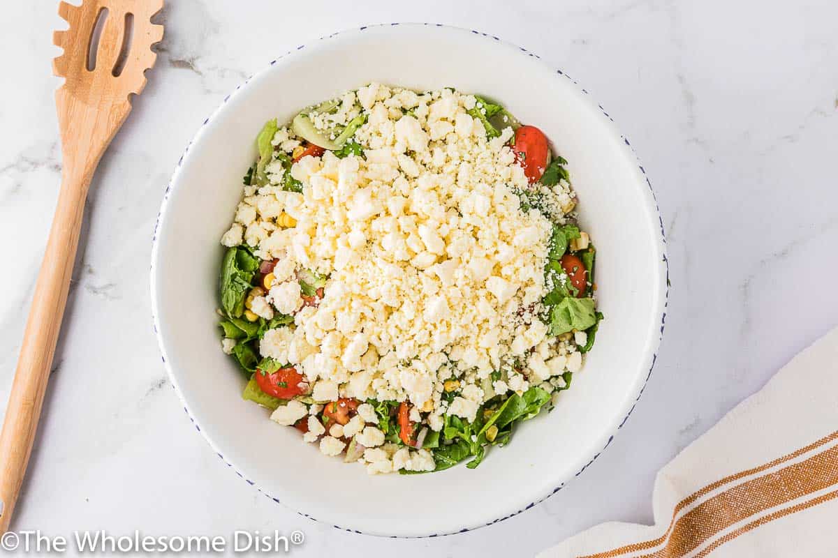Cotija cheese on top of a corn salad.