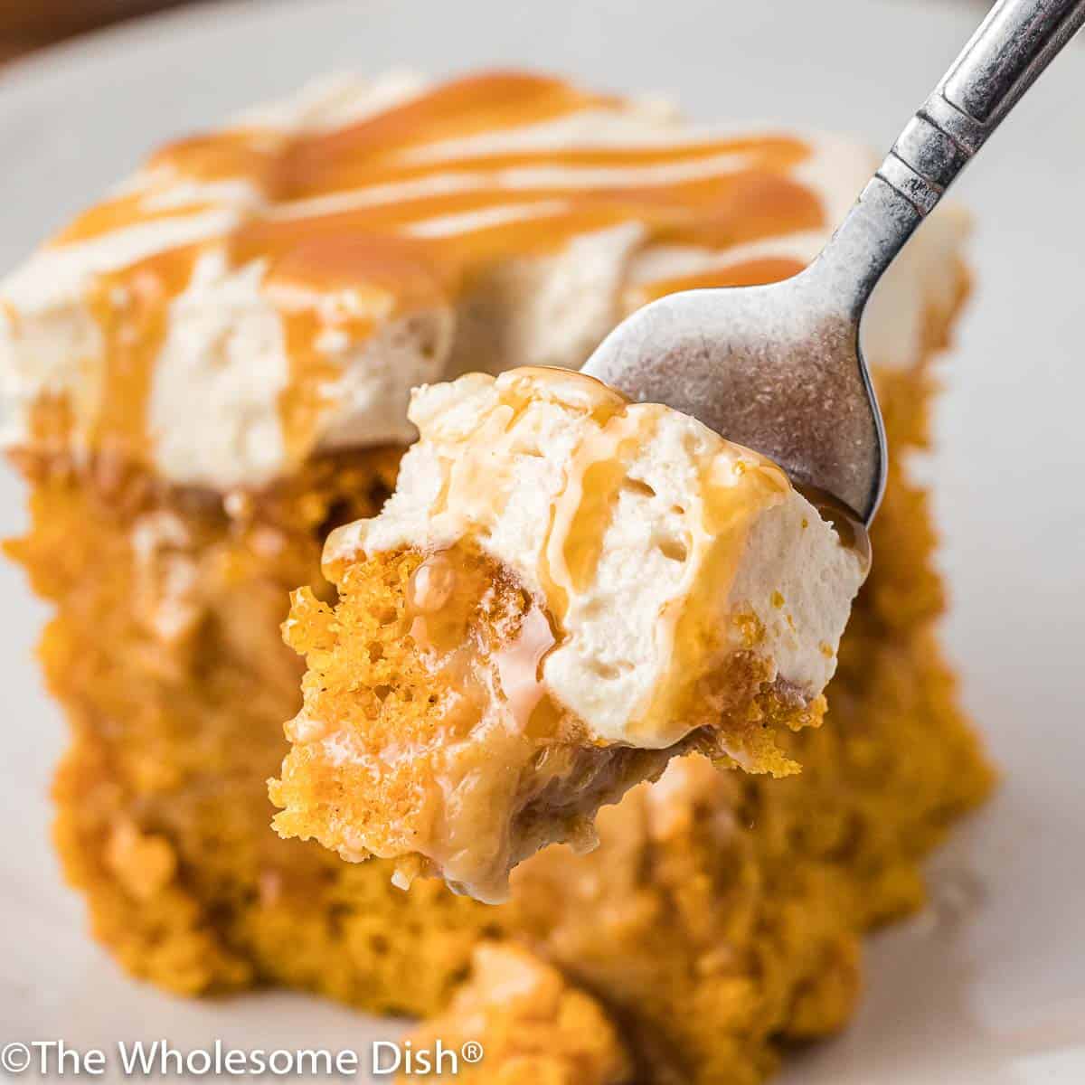 Fork full of butterscotch pumpkin poke cake.