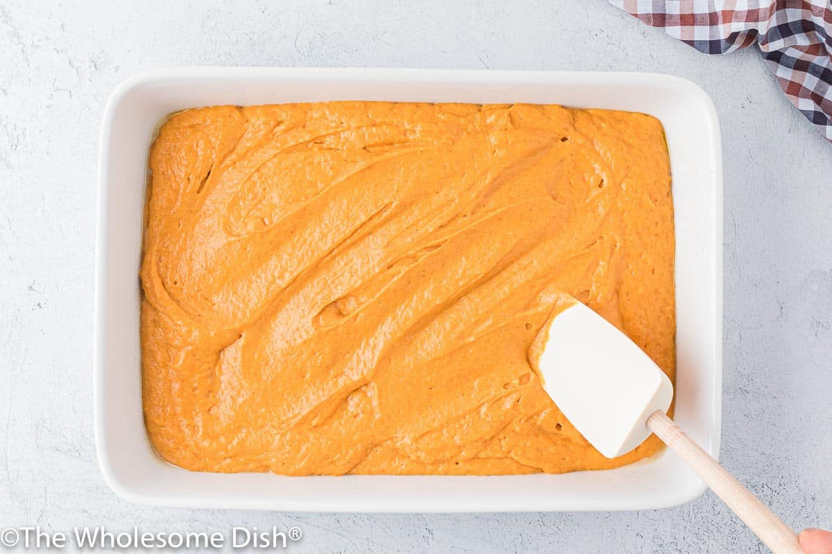 Pumpkin cake batter in a baking dish.