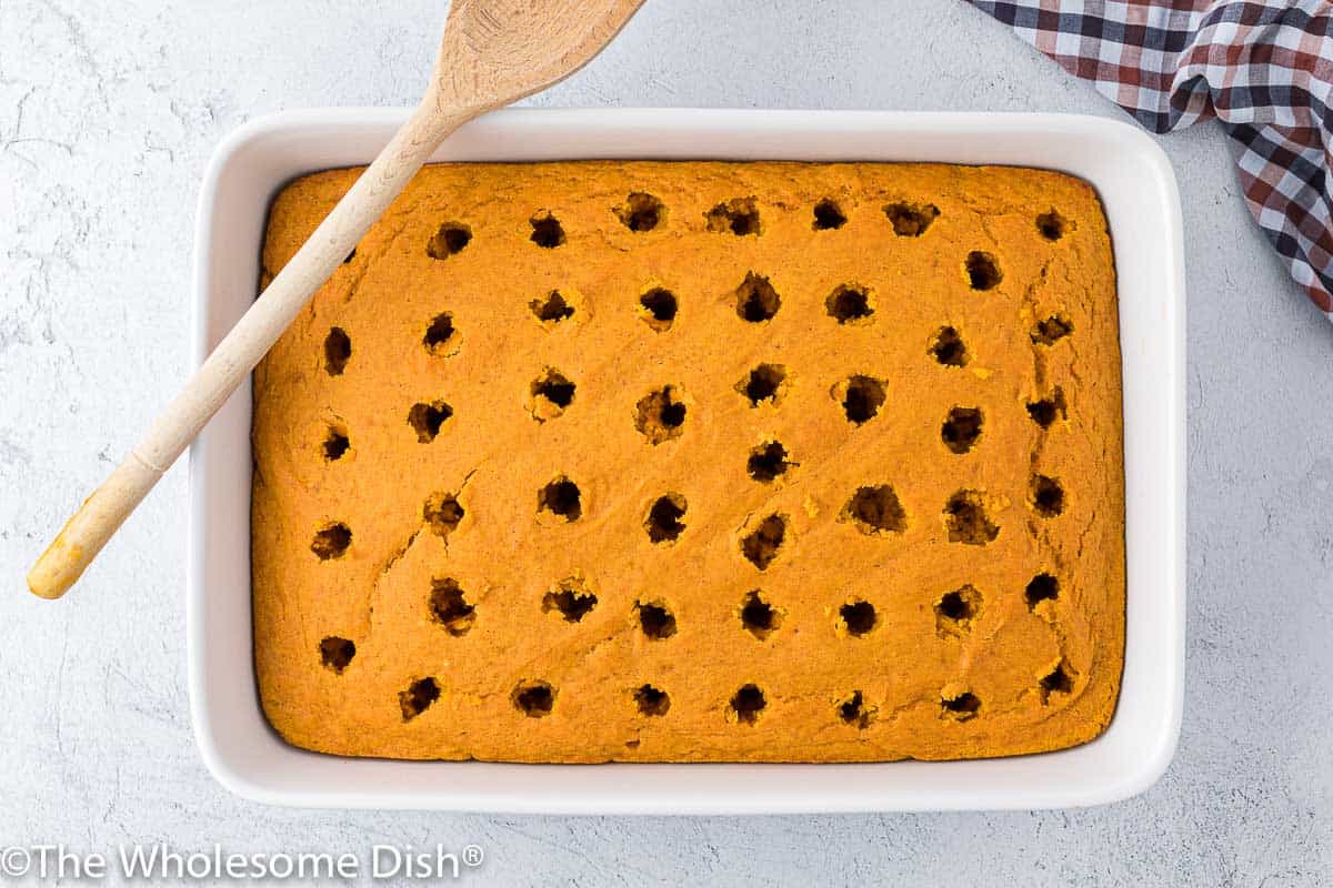 Pumpkin cake with holes poked into it.