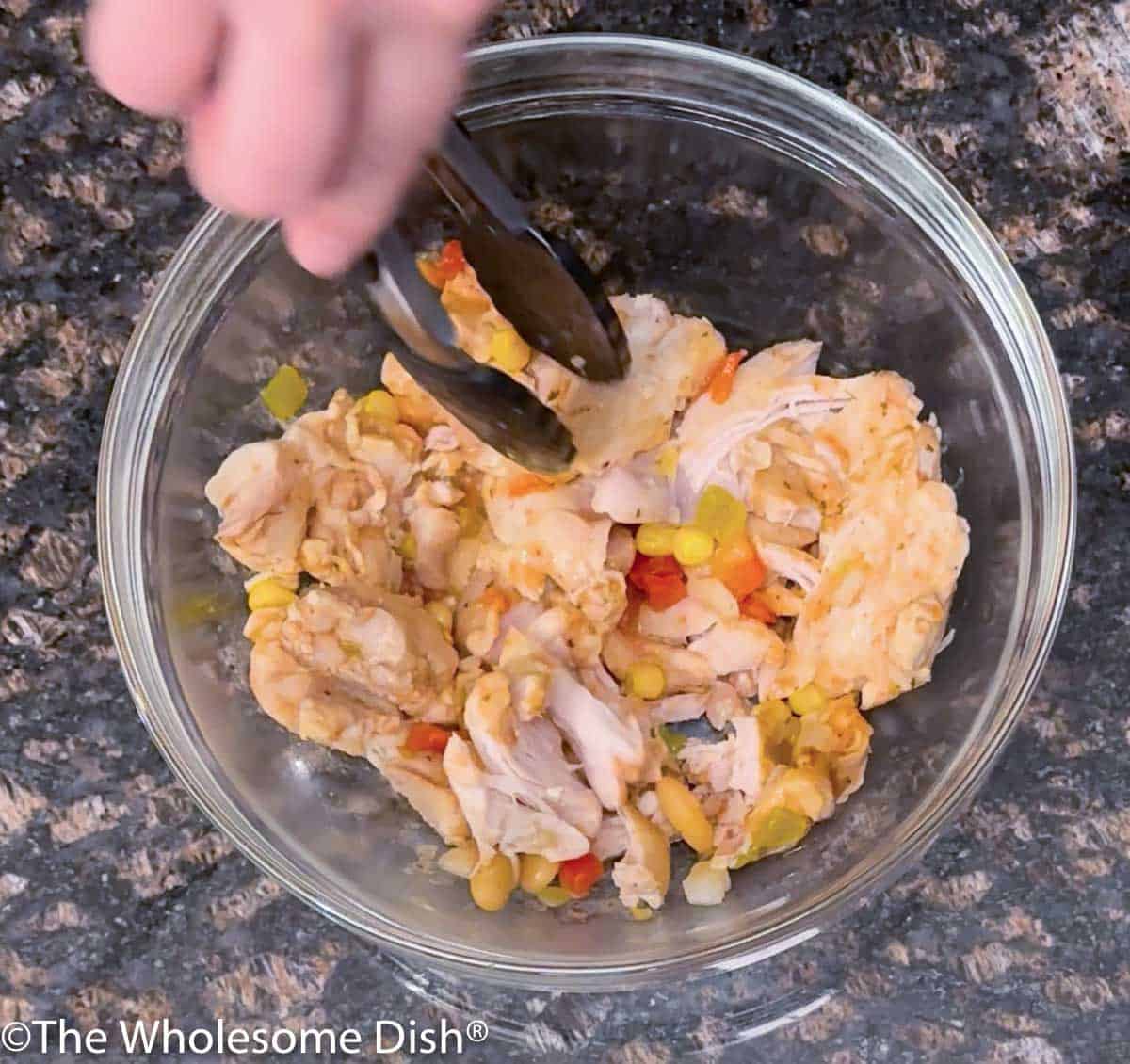 Bowl full of shredded chicken.