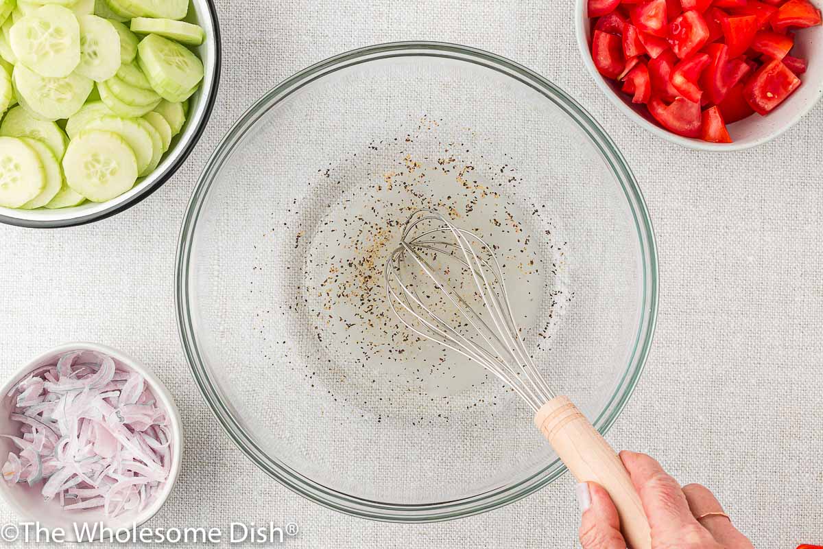 Vinegar, water, sugar, salt, and pepper in a mixing bowl.