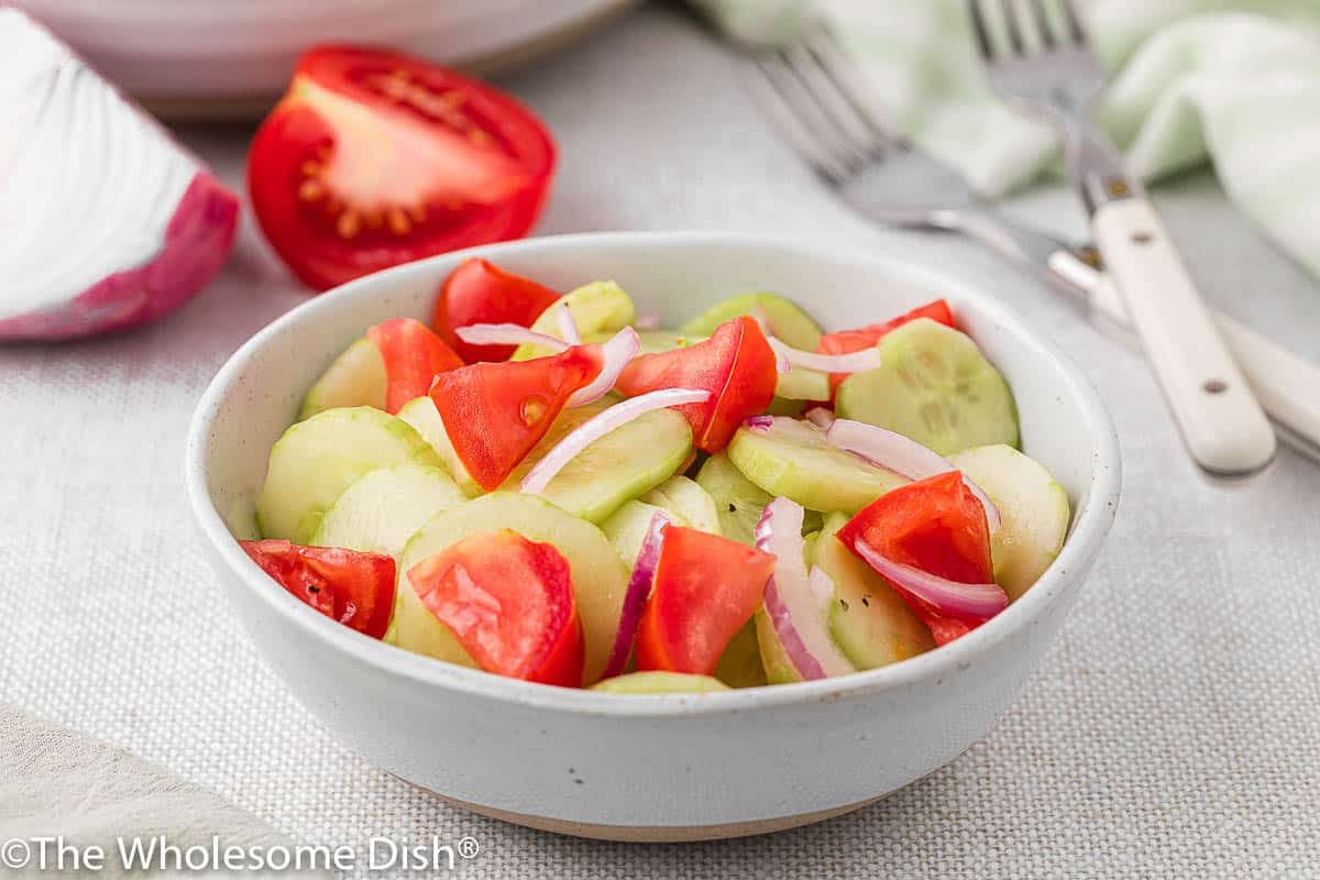 White bowl full of cucumber salad.