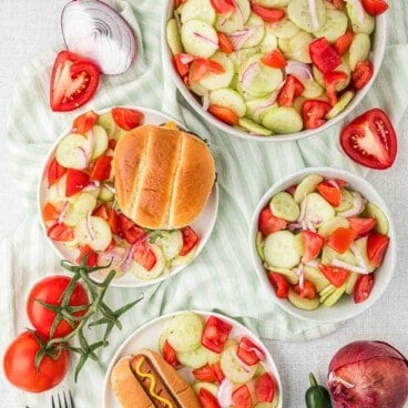 Cucumber salad being served as a side dish for burgers and hot dogs.