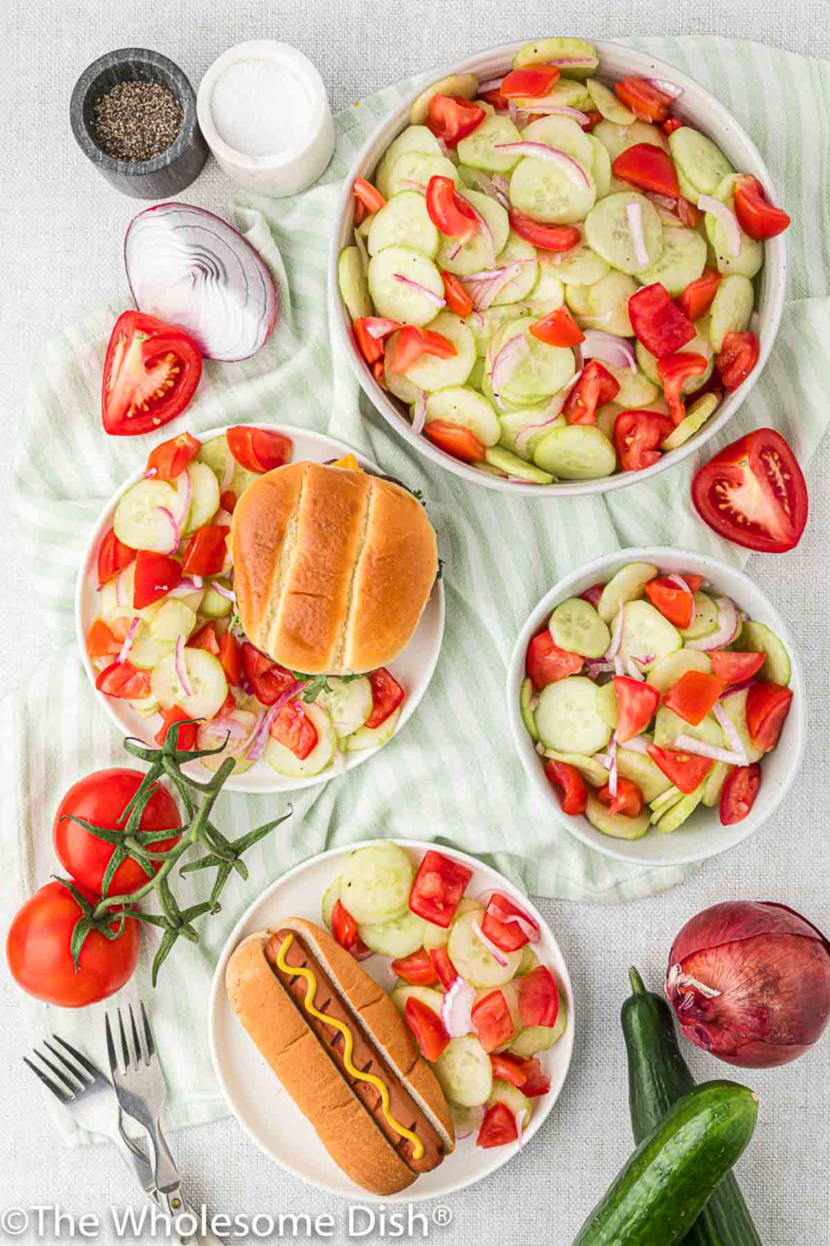 Cucumber salad being served as a side dish for burgers and hot dogs.