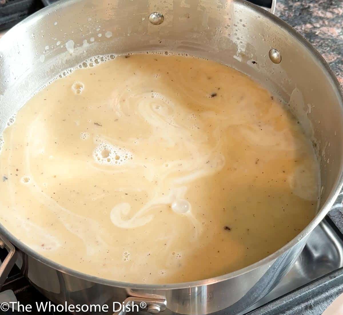 Potato soup simmering in a pot.
