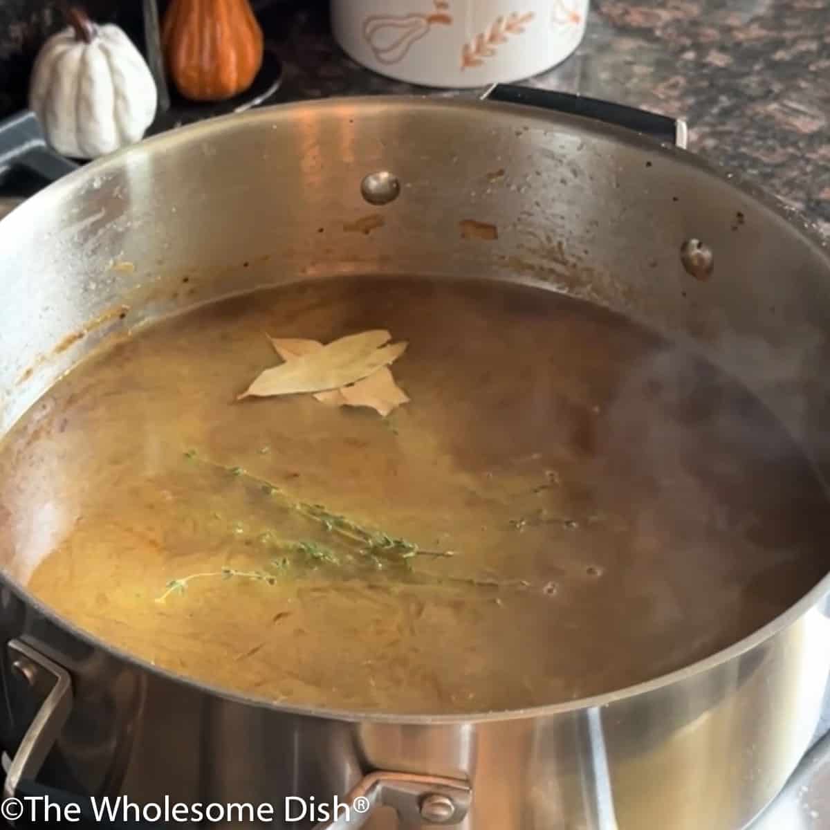 French onion soup in a soup pot.