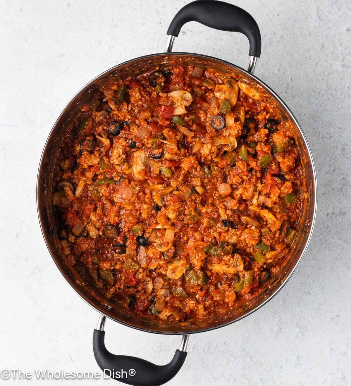 Pasta sauce and spices added to the pot.
