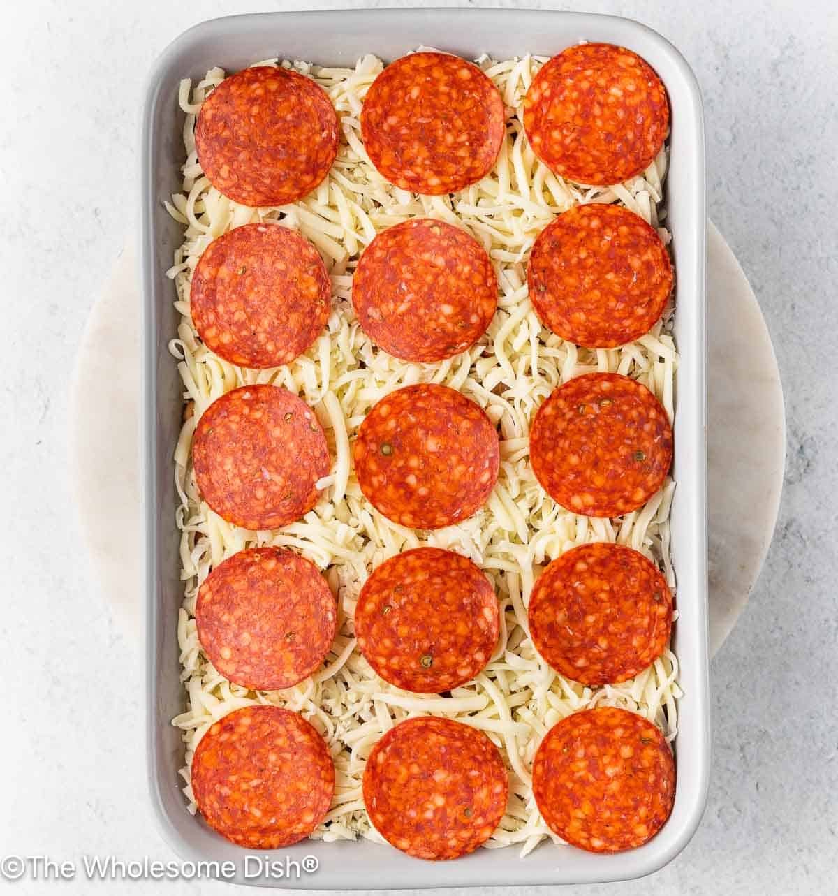 Shredded mozzarella and sliced pepperoni were added to the top of the pasta.