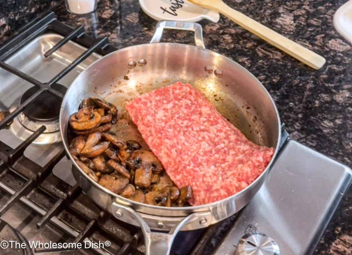 Sausage added to the skillet.