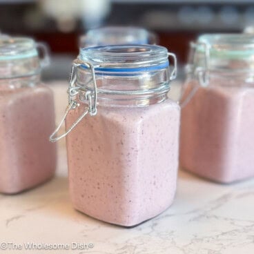 Small glass jars full of drinkable yogurt.