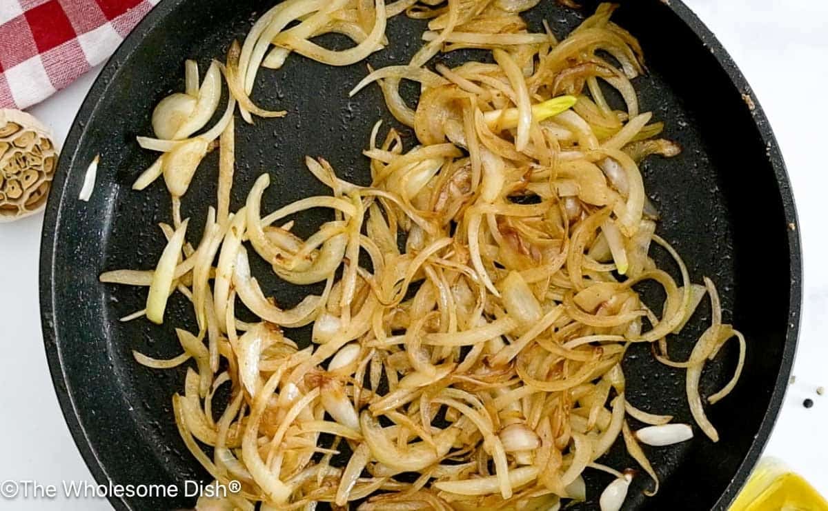 Onions sautéing in a skillet.