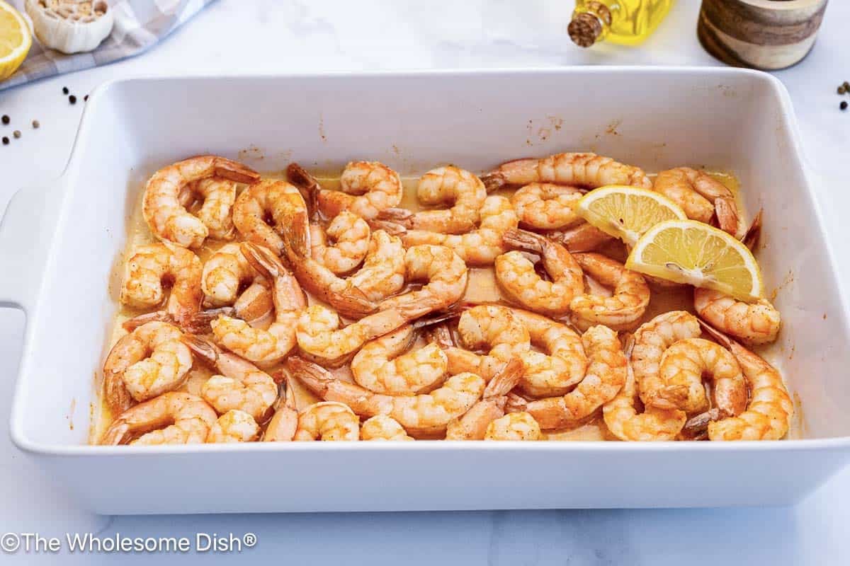 Baking dish full of baked shrimp.