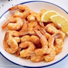 Bowl full of baked shrimp.