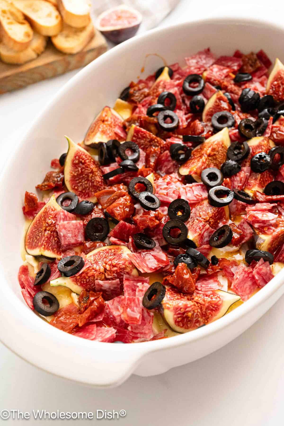White casserole dish filled with charcuterie dip.
